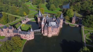 Hollanda 'nın en büyük şatosunun manzarası, De Haar. Şatonun, parkın ve kalenin etrafındaki su hendeğinin üzerinde güzel bir kuadkopter uçuşu. İngiliz tarzında güzel bir park..