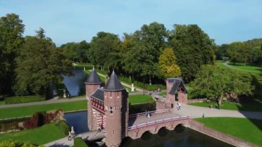 Hollanda 'nın en büyük şatosunun manzarası, De Haar. Şatonun, parkın ve kalenin etrafındaki su hendeğinin üzerinde güzel bir kuadkopter uçuşu. İngiliz tarzında güzel bir park..
