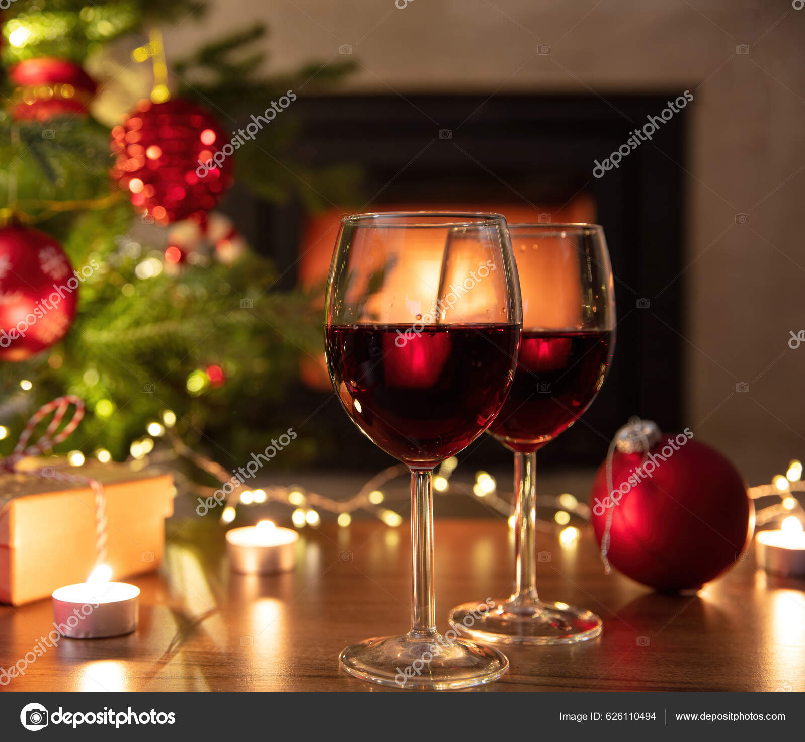 Two mulled wine glasses by the fireplace, christmas time Stock