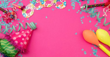 Carnival party supply. Confetti, serpentine, maraca, mask, shiny hat on pink background. Invitation card, ad template, copy space. Overhead view.