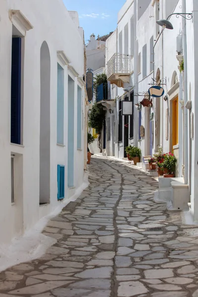 stock image Greece. Tinos island of art, Cycladic architecture at Pyrgos village paved street, whitewashed wall, stair, sunny day.