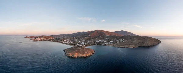 stock image Tinos island, Cyclades Greece. Aerial panoramic drone view of Agios Ioannis bay at sunset. Sandy beach and small white houses on rocky land