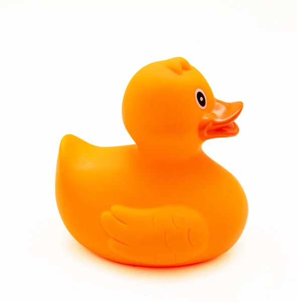Rubber duck orange color isolated on white background, side view, Baby bath fun toy.