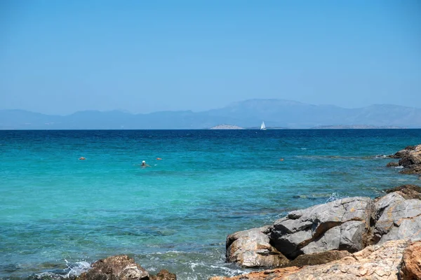 Greece Agistri Island Rocky Beach People Swimming Sailboat Sails Crystal — Stock Photo, Image