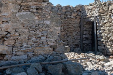 Gavdos adasında ahşap kapılı terk edilmiş taş duvar binası, Girit Yunanistan 'ın tadını çıkarın. Önceki yerleşim yerlerinin kalıntıları
