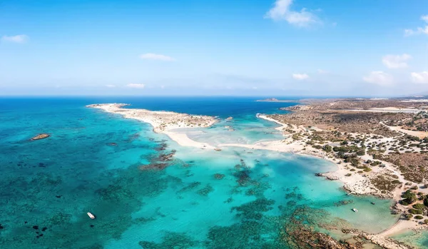 stock image Elafonisi Crete island Greece. Aerial drone view of turquoise transparent sea water, moored boat, blue sky, beach with pink sand. Famous resort.