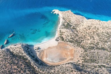 Cape Tripiti at Gavdos southernmost Greek island, Crete. Aerial drone view of beach, wild landscape, vast clear turquoise ripple Libyan sea water. clipart