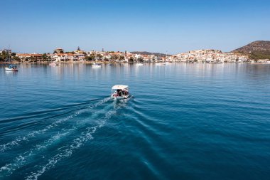 Greece, Aerial drone view of Ermioni, a small port town in Argolis, Peloponnese, Seafront buildings on the coast and boats in the sea, blue sky clipart