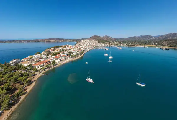 stock image Greece, Aerial drone view of Ermioni, a small port town in Argolis, Peloponnese, Seafront buildings on the coast and boats in the sea, blue sky