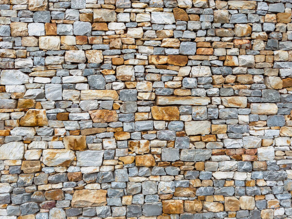 Stonewall background texture. building facade stone wall material detail