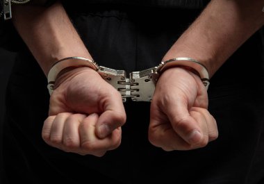 Eller kelepçeli, yakın çekim görüntüsü. Suç, tutuklama ve hapis kavramı