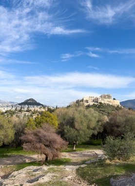 Athens, Greece. Parthenon, Acropolis hill and mount Lycabettus view from Areopagus hill, blue sky with clouds clipart