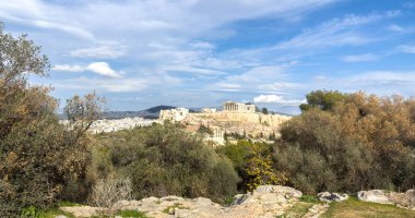 Athens, Greece. Parthenon and Propylaea, Acropolis hill and Herodeion. View from Philopappos hill, blue sky with clouds clipart