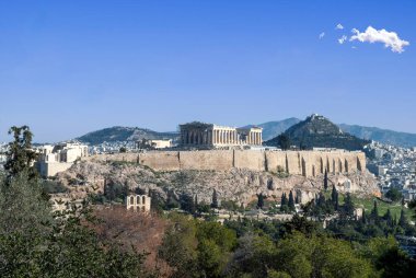 Athens, Greece. Parthenon and Propylaea, Acropolis hill, Herodeion and mount Lycabettus, blue sky. clipart