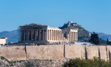 Athens, Greece. Parthenon on Acropolis hill, and mount Lycabettus, blue sky. clipart