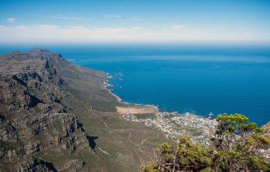 Cape town aerial view, Table mountain cliffs over Atlantic ocean, sandy beaches and Camps Bay, blue sky clipart