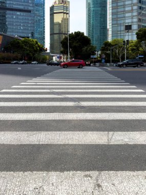 31 Mart 2025. Çin. Şangay 'da. Şehir merkezinde yaya geçitleri ve kırmızı trafik ışığı olan bir cadde. Yüksek binalar.
