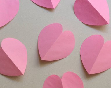 pink paper hearts on white background clipart