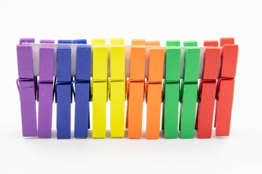colorful household wooden clothes pins isolated on white background.