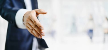 İş adamı elini açıp anlaşmaya hazır, ortak el sıkışıyor.