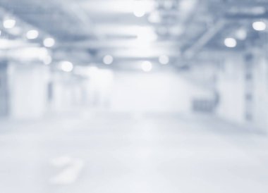 Bulanık yeraltı otoparkının arka planında parlak ışıklar var.