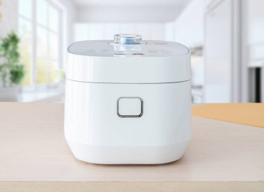 Işıl ışıl, rahat bir mutfakta, içi buharda pişmiş pirinçle dolu minimalist bir pilav fırını. Modern ev aletleri veya sağlıklı yemek çözümleri ile ilgili reklamlar için harika..