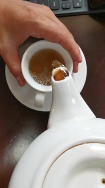 This video captures the process of pouring herbal tea from a white teapot into a cup, creating a calming, refreshing ritual. The warm liquid and its soothing aroma create a sense of comfort and warmth