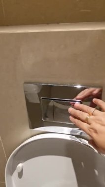 A close-up video showcasing a modern toilet flushing mechanism, highlighting the dual flush system for water conservation and efficient hygiene practices.