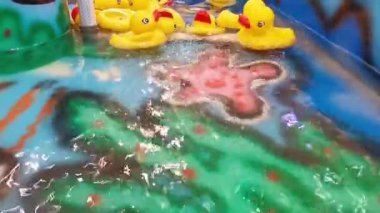 Experience the charm of numerous yellow rubber ducks gently drifting across a vibrant water display. Perfect for capturing the carefree spirit of childhood, this lively scene exudes joy and amusement.