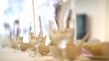 A video displaying an exquisite table arrangement featuring gleaming glassware. Ideal for showcasing the elegance of a wedding reception or a sophisticated dining experience. Perfect for caterers.