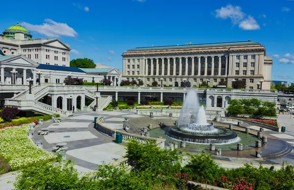 stock image Government building with a water fountain in the plaza of the entrance.  Large open space showing some of the landscaping and area around the public complex.