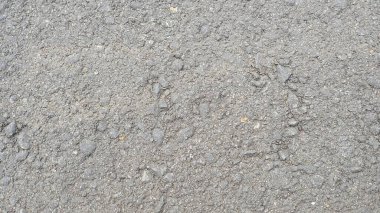 Bir gün ışığında asfalt dokusunun yakın plan fotoğrafı.