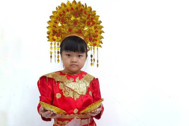 Asian child, cute little girl, wearing Baju Bundo Kanduang or Baju Kurung, Padang or Minangkabau traditional clothes. Wearing a traditional headpiece 'Suntiang'. isolated with white background clipart