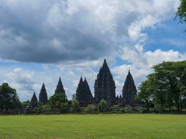 Antik Taş Prambanan Tapınakları, Yogyakarta. Parlak Mavi Gök 'e Karşı Ayakta Kalın, Bulutlu Gök Altında Görkemli Mimari Mucizeler. Tarihi Yapılar, Kültür Mirası