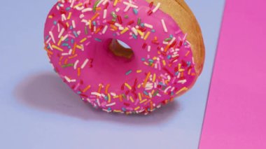 Pembe ve mavi arka planda taze pişmiş donut.