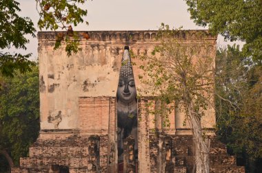 ancient architecture of Buddhist temples in Sukhothai. Statue of Buddha Phra Achana at Wat Si Chum , Thailand