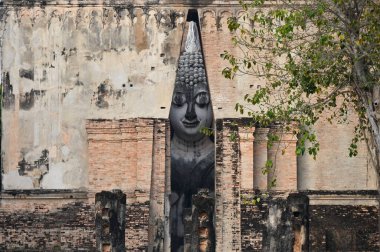 ancient architecture of Buddhist temples in Sukhothai. Statue of Buddha Phra Achana at Wat Si Chum , Thailand