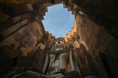 ancient architecture of Buddhist temples in Sukhothai. Statue of Buddha Phra Achana at Wat Si Chum , Thailand
