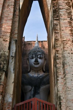 ancient architecture of Buddhist temples in Sukhothai. Statue of Buddha Phra Achana at Wat Si Chum , Thailand