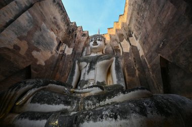 ancient architecture of Buddhist temples in Sukhothai. Statue of Buddha Phra Achana at Wat Si Chum , Thailand