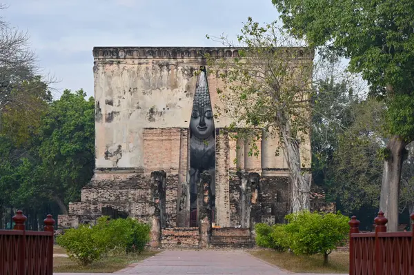 ancient architecture of Buddhist temples in Sukhothai. Statue of Buddha Phra Achana at Wat Si Chum , Thailand