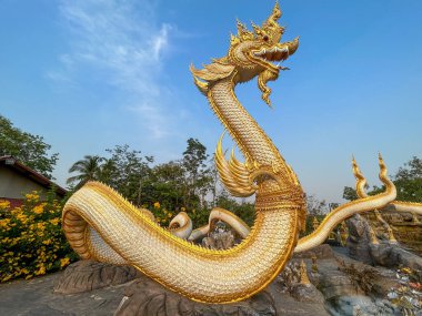 Majestic Golden Naga Sculptures.Wat Sri Sa At, Roi et, Thailand clipart