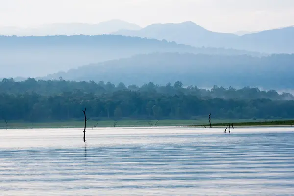 stock image A beautiful landscape of fog covered mountains and bhadra forest in the backwaters of Bhadra river inside Bhadra tiger reserve during a wildlife safari