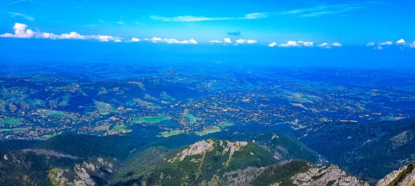 stock image Panoramic view of the city Zakopane from Giewont Mountain. Journey to the mountains. Hiking in the Tatra Mountains. Mountain peaks with valleys between them. Active lifestyle. 