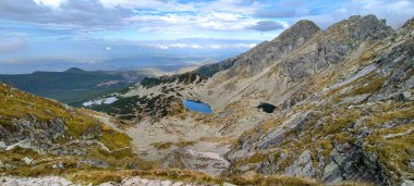 Hiking in the mountains as a favorite hobby. Active lifestyle. Views of the Tatra Mountains and the High Tatras from hiking trails. Mountain peaks, slopes, lakes and valleys between mountains clipart