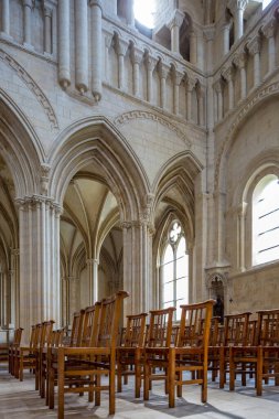 Fransa 'nın Normandiya eyaletinin Caen kentindeki Abbaye aux Dames' in sakin iç mekanı. İçinde ahşap sandalyeler ve büyük vitray pencerelerle Gotik mimari yer alıyor..