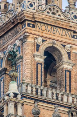 Close-up of the bell tower body of the Giralda, featuring the Latin inscriptions 'Fortissima' and 'Nomen Domini', located in Seville, Spain. clipart