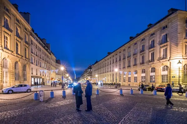 stock image Eiffel Towers light beam visible from Pantheon square in the evening.