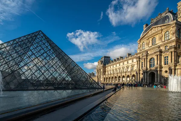 stock image Visitors walking near the Palais Royal under a clear blue sky.