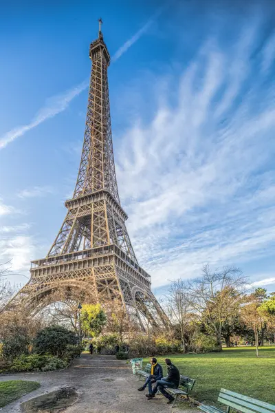 stock image Two men sitting on a bench in front of the Eiffel Tower, Paris, France